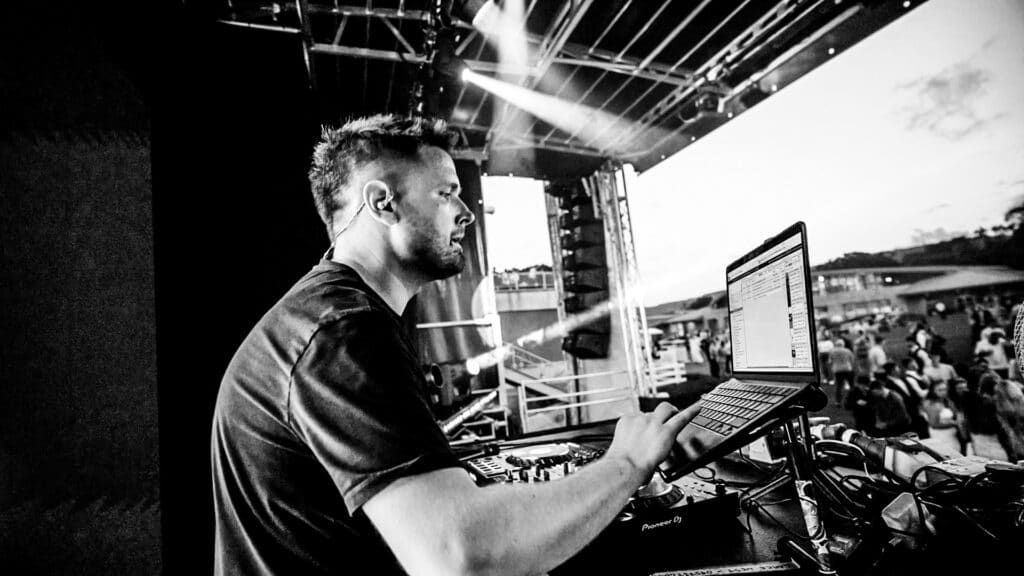 Picture of Lance on laptop on Festival Stage from Body Funk - Contact information for enquiries."